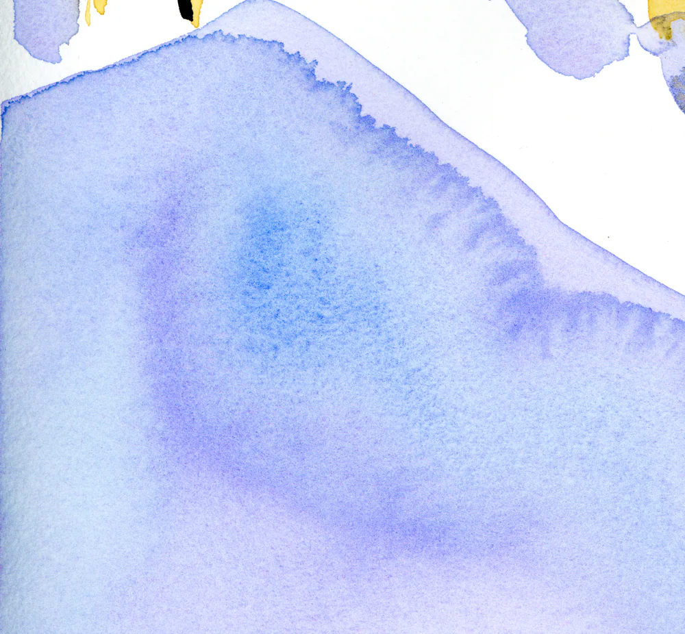 Close view of a violet and blue wash whose upper edge breaks into a soft, feathered line.